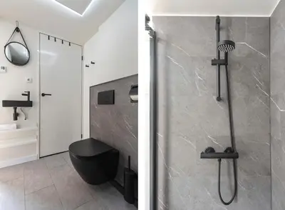 a bathroom with a shower with a black toilet at Flamingo Beach Apartments in Zandvoort
