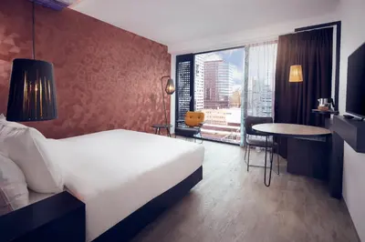 a hotel room with a bed and a table and a window at Inntel Hotels Utrecht Centre in Utrecht