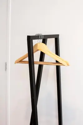 a metal and wood stand with a pair of shoes on it at Kuwadro Guesthouse Centrum in Amsterdam