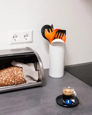 a kitchen counter with a toaster and a cup of coffee at Kuwadro Guesthouse Centrum in Amsterdam