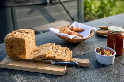 a table with bread and a bowl of bread and a knife at Amsterdam Area Residence Oosterwold in Almere