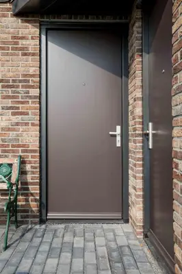 a garage door with a bench next to a brick building at Amsterdam Area Residence Oosterwold in Almere