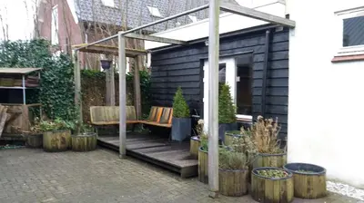 a patio with a bench and a pergola at Hannahhoeve Private House with wifi and free parking for 1 car in Weesp