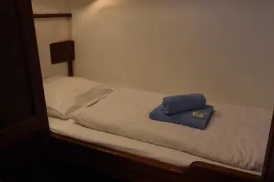 a bed with a blue towel on top of it at MPS Flora in Amsterdam
