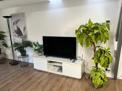 a flat screen tv sitting on a white entertainment center at Appartementen Purmerend A in Purmerend