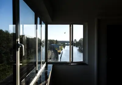 a room with a window with a view of a river at SWEETS - Gerben Wagenaarbrug in Amsterdam