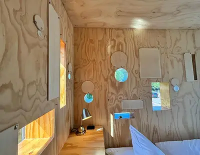 a room with a bed and a wall with wood paneling at SWEETS - Gerben Wagenaarbrug in Amsterdam