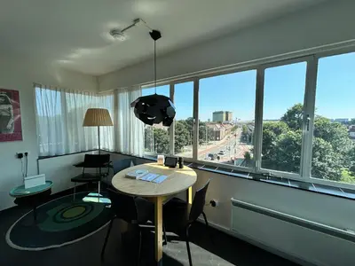 a room with a table and chairs and a large window at SWEETS - Gerben Wagenaarbrug in Amsterdam
