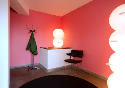 a room with a red wall with a table and a chair at SWEETS - Gerben Wagenaarbrug in Amsterdam