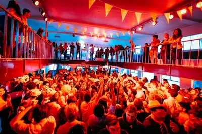 a large crowd of people dancing in a room at The ESN Kingsday Campsite in Amsterdam