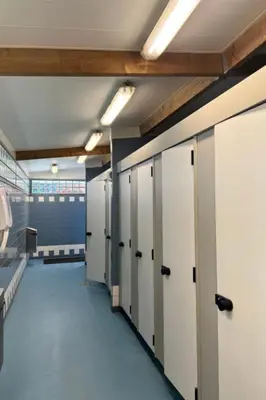 an empty room with lockers and a corridor in a building at The ESN Kingsday Campsite in Amsterdam
