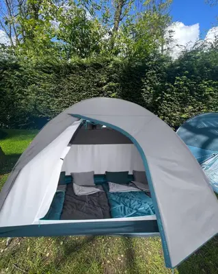 a tent is set up in the grass at The ESN Kingsday Campsite in Amsterdam