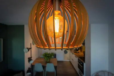 a large light hanging over a dining room table at CasaMare in Egmond aan Zee
