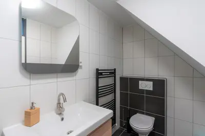 a bathroom with a sink and a toilet at CasaMare in Egmond aan Zee