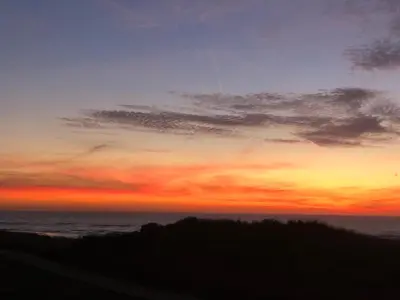 a sunset over the ocean with the sky at CasaMare in Egmond aan Zee