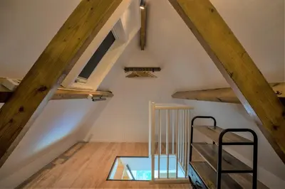 a room with wooden beams and a glass floor at CasaMare in Egmond aan Zee