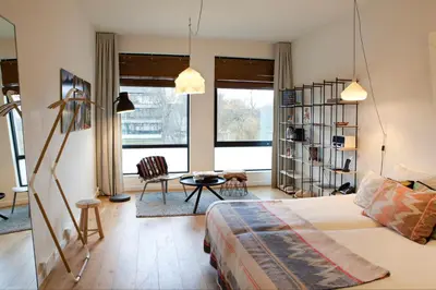 a living room with a bed and a table and chairs at Skotel Amsterdam, Hotelschool The Hague in Amsterdam