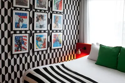 a bedroom with a black and white patterned wall at Skotel Amsterdam, Hotelschool The Hague in Amsterdam