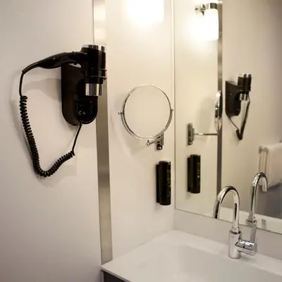a bathroom with a phone and a sink at Skotel Amsterdam, Hotelschool The Hague in Amsterdam