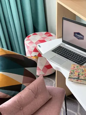 a laptop computer sitting on a desk next to a chair at Hampton By Hilton Utrecht Centraal Station in Utrecht