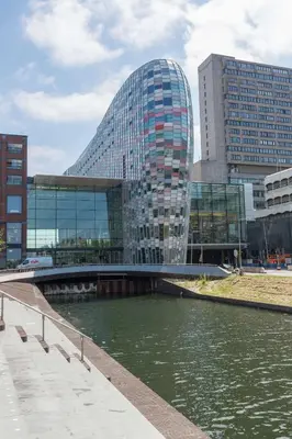 a bridge over a river in front of a building at Hampton By Hilton Utrecht Centraal Station in Utrecht