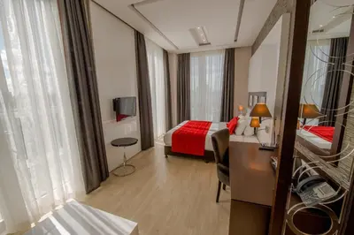 a hotel room with a bed and a desk in it at Grand Hotel Downtown in Amsterdam