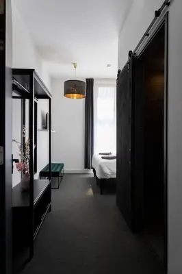 a hotel room with a bed and a mirror at Hotel en Stadscafé de Dam l Hotel Monnickendam in Monnickendam