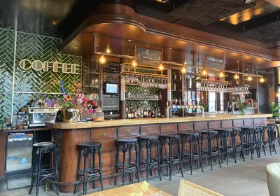 a bar with a lot of bar stools at Hotel en Stadscafé de Dam l Hotel Monnickendam in Monnickendam