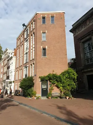 a tall brick building on the side of a street at Canal view suite in Amsterdam