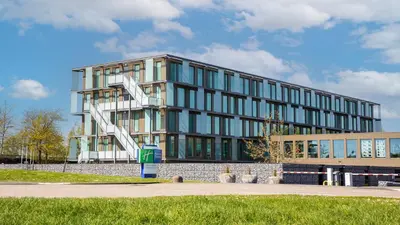 a building with a sculpture in front of it at Holiday Inn Express Utrecht - Papendorp by IHG in Utrecht