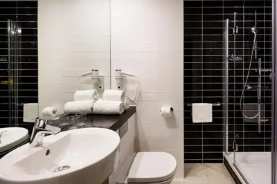 a bathroom with a sink and a toilet and a shower at Holiday Inn Express Utrecht - Papendorp by IHG in Utrecht