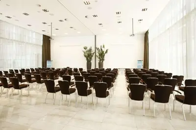 a large room with chairs and a podium in it at NH Amersfoort in Amersfoort