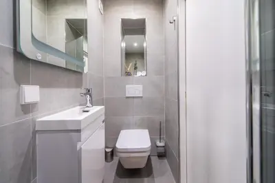 a bathroom with a white toilet and a sink at Prinsengracht Canal Studios in Amsterdam