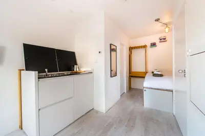 a room with a sink and a bed in it at Prinsengracht Canal Studios in Amsterdam