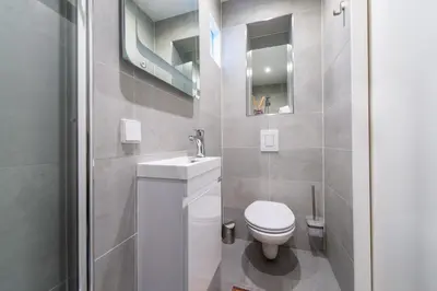 a bathroom with a white toilet and a sink at Prinsengracht Canal Studios in Amsterdam