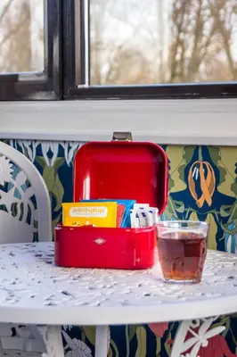 a red lunch box sitting on a table at SWEETS - Meeuwenpleinbrug in Amsterdam