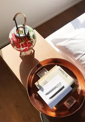 a table with a plate and a lamp on a bed at SWEETS - Buiksloterdraaibrug in Amsterdam