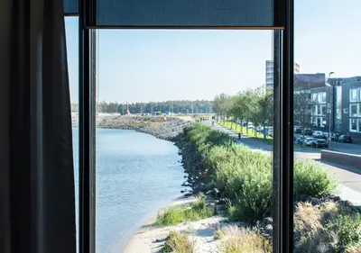 a view of a river from a window at SWEETS - Sluis Haveneiland in Amsterdam