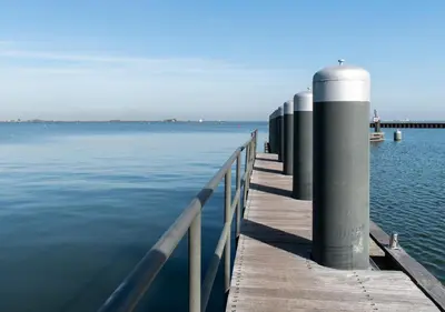 a dock on the water next to a pier at SWEETS - Sluis Haveneiland in Amsterdam