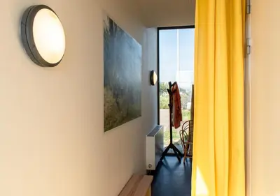 a room with a yellow curtain and a mirror at SWEETS - Sluis Haveneiland in Amsterdam