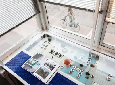 a room with a window and a person on a bike at SWEETS - Westerdoksbrug in Amsterdam