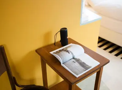 a table with an open book on it next to a bed at SWEETS - Kattenslootbrug in Amsterdam