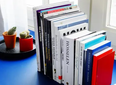 a pile of books sitting on a table at SWEETS - Beltbrug in Amsterdam