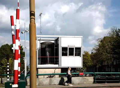 a woman walking in front of a building at SWEETS - Wiegbrug in Amsterdam