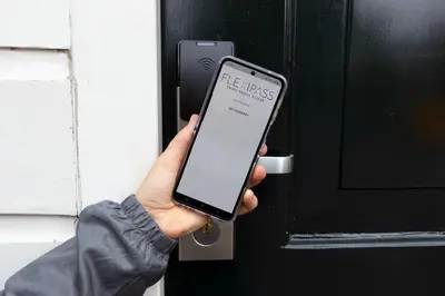 a person holding a smart phone in front of a door at SWEETS - Kinkerbrug in Amsterdam