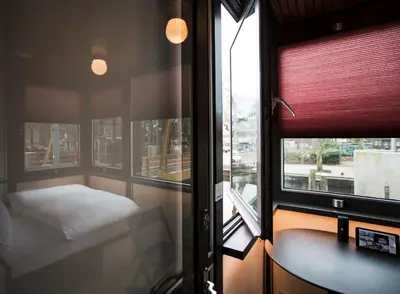 a small room with a table and a window at SWEETS - Theophile de Bockbrug in Amsterdam