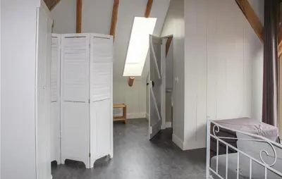 a room with a bed and a white closet at De Koestal in Wijdenes