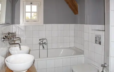 a bathroom with a tub and a toilet and a sink at De Koestal in Wijdenes
