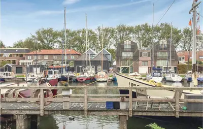 a group of boats are docked at a dock at De Koestal in Wijdenes