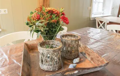 a table with a vase of flowers on top of it at De Koestal in Wijdenes